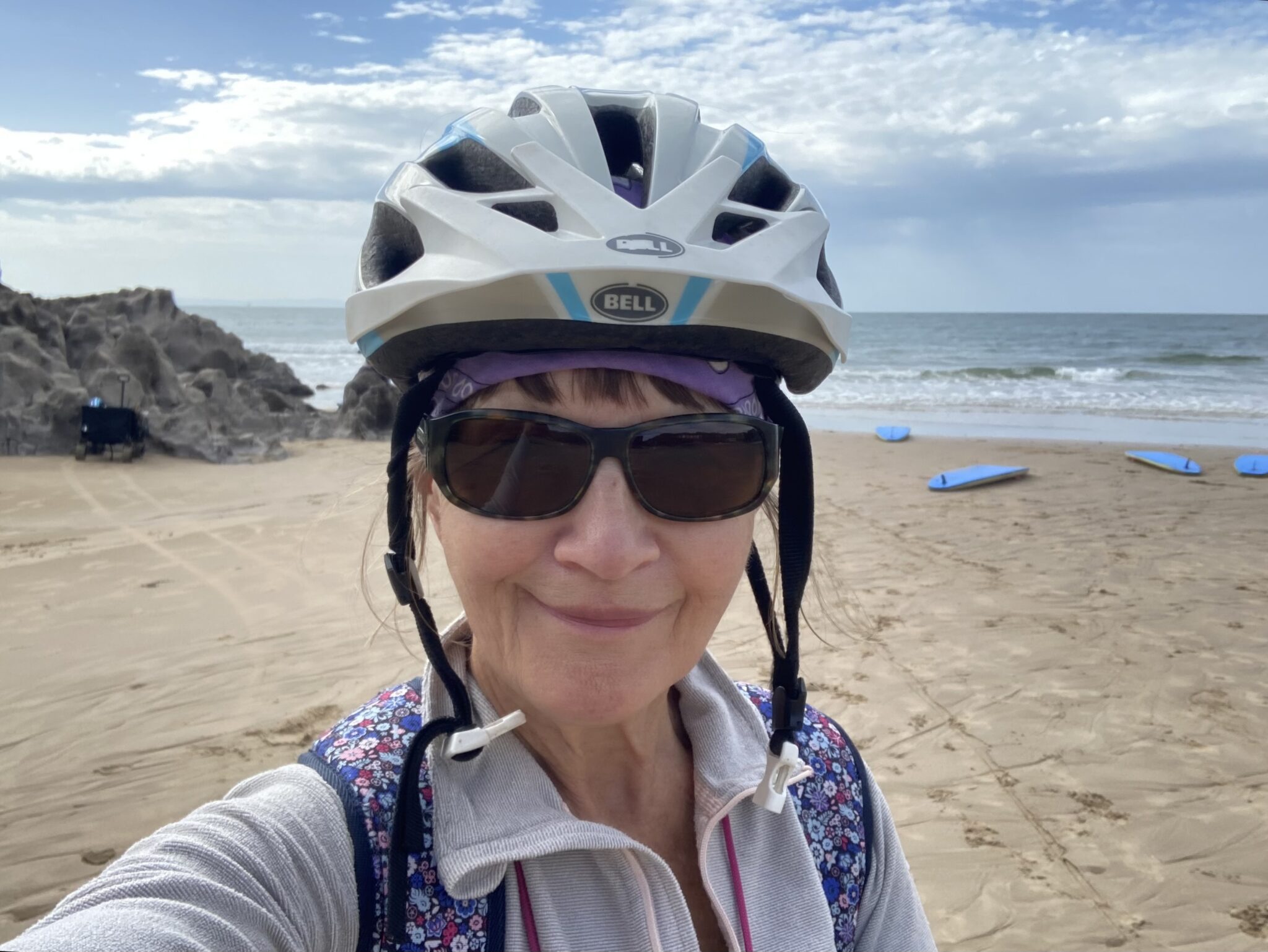 Steph M. in a bike helmet on a beach in Wales, who shared her Next Level Soul story